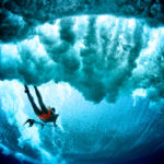 Dark cloudy duck dive surfer